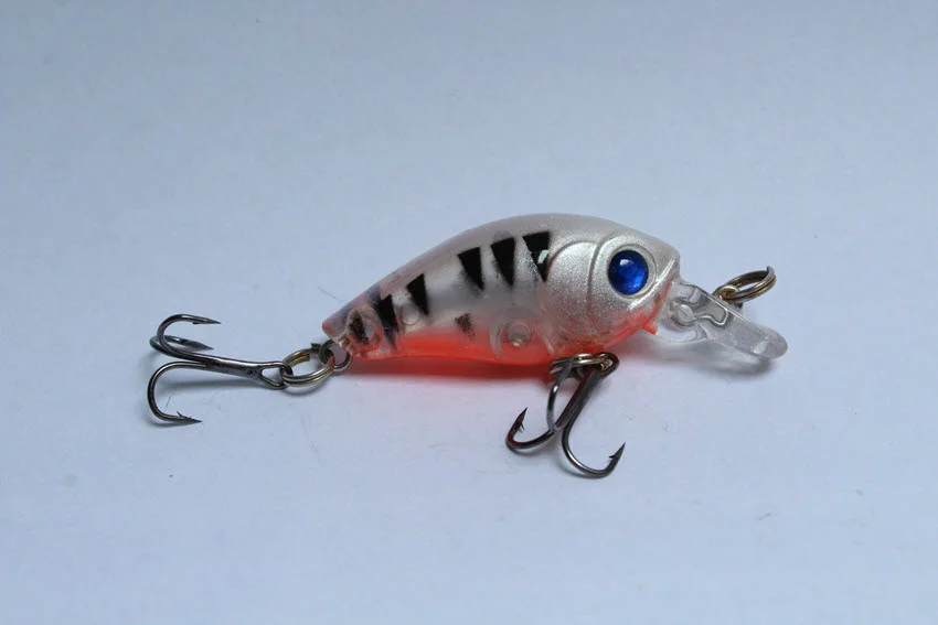 Small white wobbler crank bait for fishing isolated on a white background.