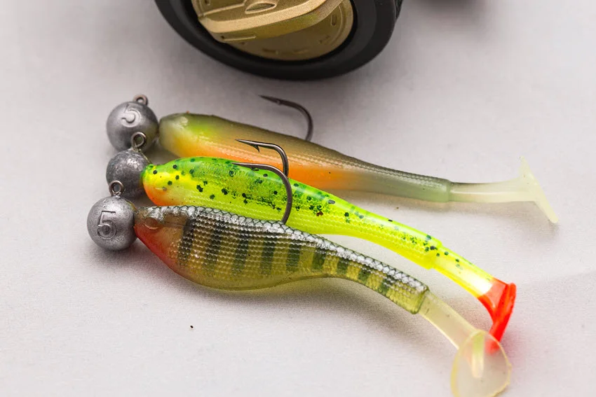 Close shot of soft rubber lures and jig heads arranged for inshore Flounder fishing.