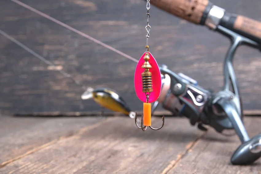 Inline spinner lure hanging from a spinning rod, showing a simple and effective lure choice for Salmon fishing in rivers, streams, and nearshore water.