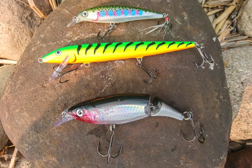 Close-up of large Jerkbait lures with vivid patterns and treble hooks ready for Snapper fishing.