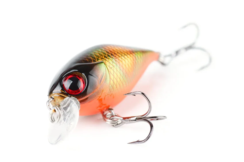 Close view of a Rattler Crank plastic fishing lure with treble hooks, isolated on a white background.