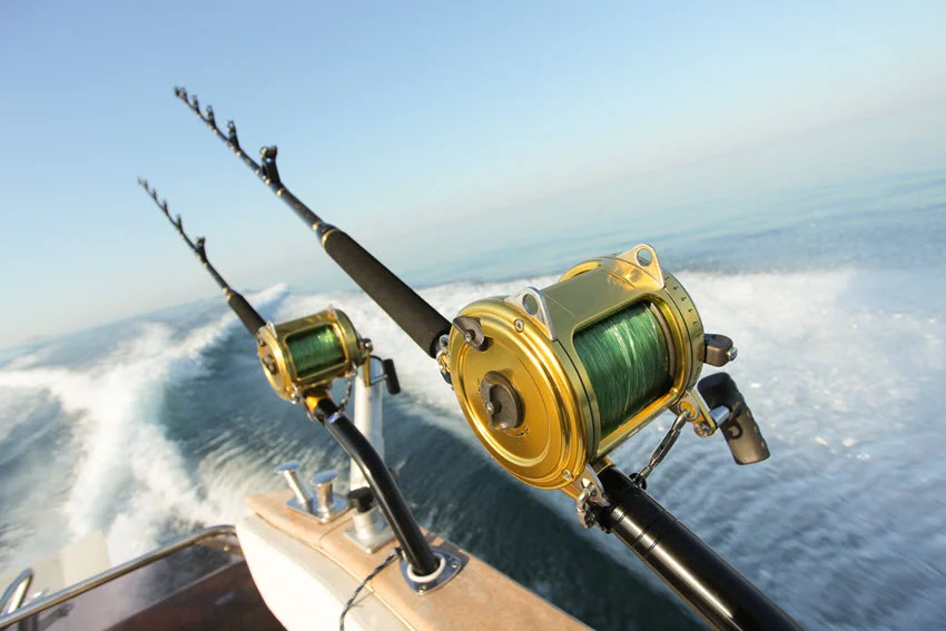 Big game fishing reels and rods arranged together, designed for catching large fish species in deep sea fishing adventures.