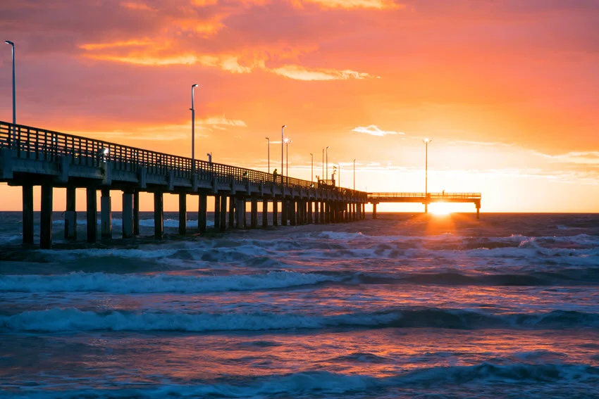 Bob Hall Pier on Padre Island near Corpus Christi, Texas, extending into the Gulf of Mexico. A popular fishing and sightseeing destination, the pier offers stunning ocean views and a serene coastal atmosphere.