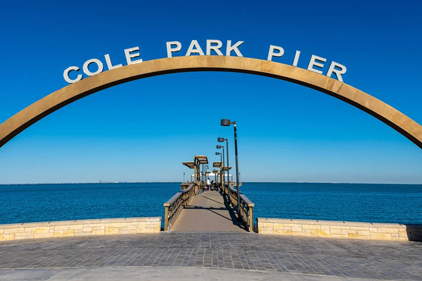 Historic Cole Park Pier on Ocean Drive in Corpus Christi, Texas, extending over the waters of Corpus Christi Bay. A scenic coastal landmark, the pier offers a popular spot for fishing, sightseeing, and enjoying ocean views.
