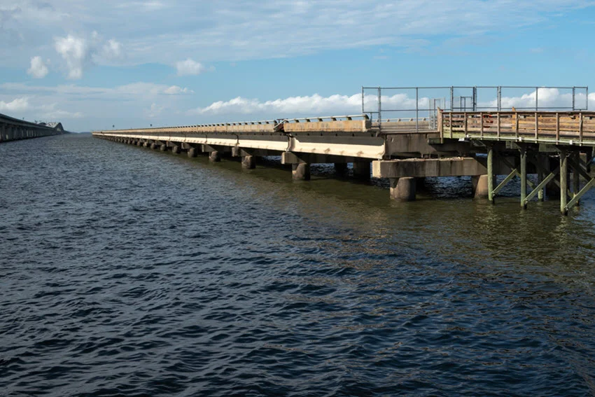 View of fishing pier constructed from the remnants of Lake Pontchartrain's bridge, stretching over the vast waters of Lake Pontchartrain, Louisiana.