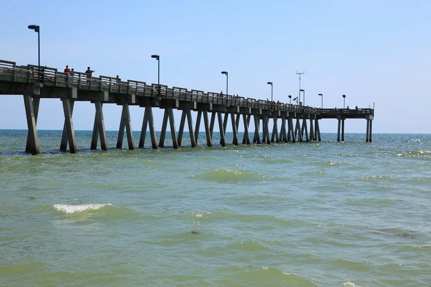 Public fishing pier in Sarasota, Florida, extending into the Gulf of Mexico. The pier offers a scenic view of the expansive waters, inviting anglers and visitors to enjoy the coastal beauty and peaceful ambiance of the area.