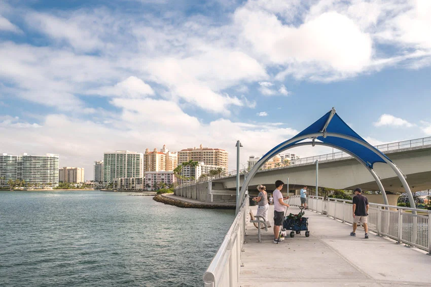 View of the newly renovated fishing pier in Sarasota, Florida, with several people fishing.