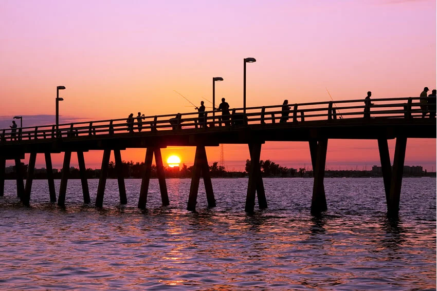 A view of an angler's silhouette during sunset at the fishing pier in Sarasota, Florida.