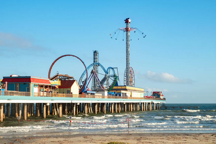 Panoramic view of Pleasure Pier on a sunny day taken from the water near Galveston Island.