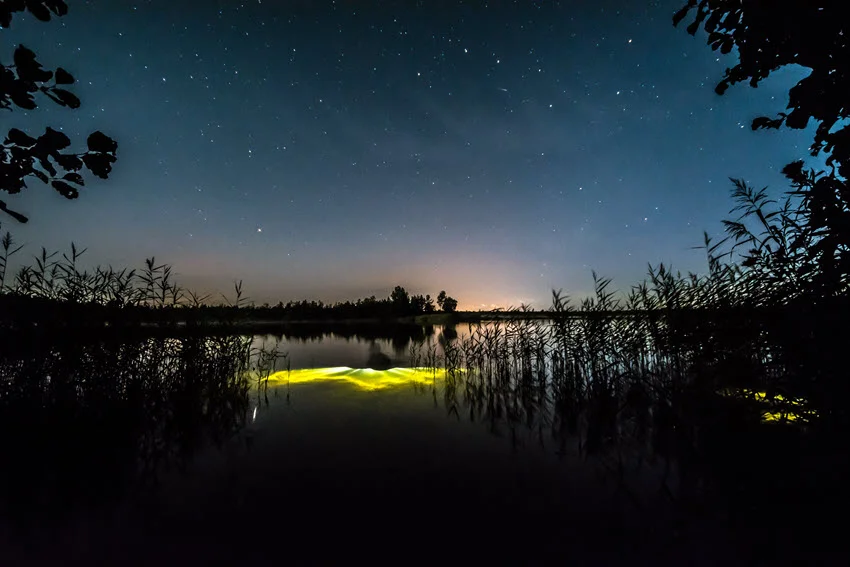 The panoramic shot of underwater night fishing lights in the lake.