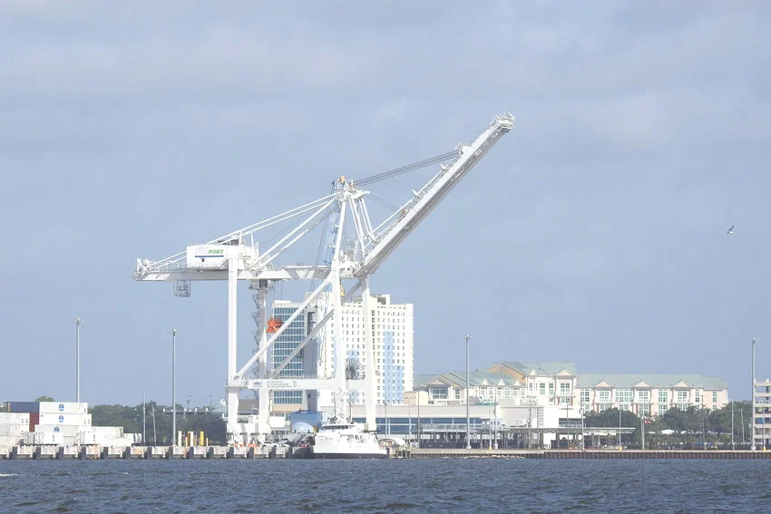 Gulfport harbor viewed from the sea, featuring a large shipping crane and the main waterfront buildings.