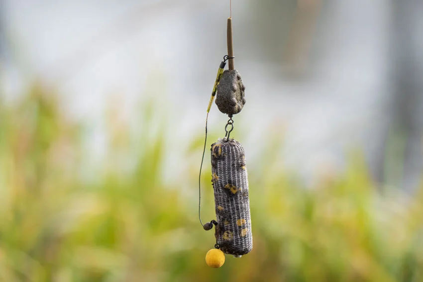Focused shot of a fishing rig with a blurred green background.