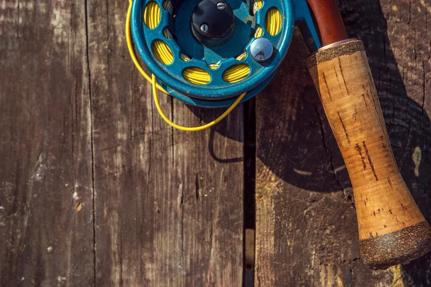 Close shot of popping cork fishing gear resting on a wooden surface.