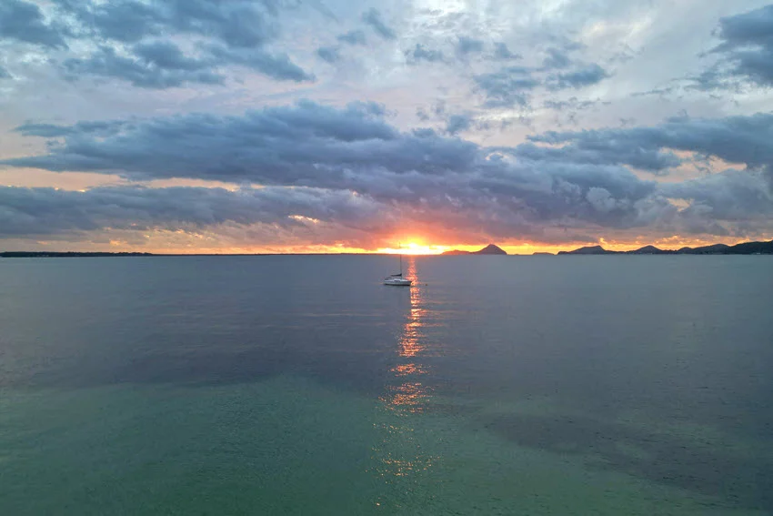 A tranquil sunrise at Kangaroo Point Reserve, Soldiers Point, Port Stephens, NSW, Australia, with soft golden light illuminating the calm waters and surrounding nature.