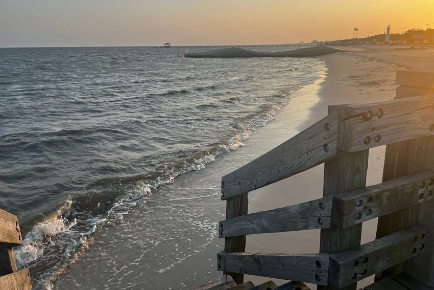 Panoramic photo of Gulf Shore boardwalk and beach during sunset.