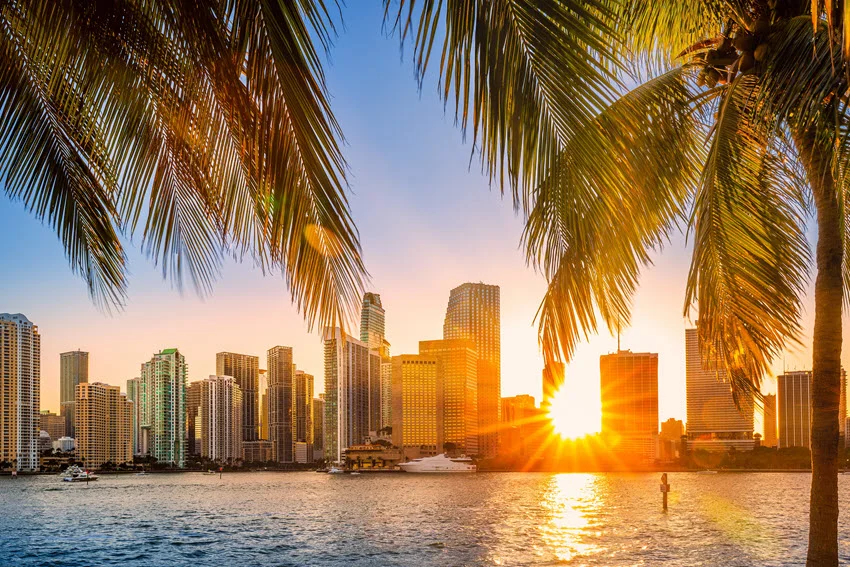 Miami skyline glowing at sunset beside the water in South Florida, a leading destination for urban Peacock Bass fishing.