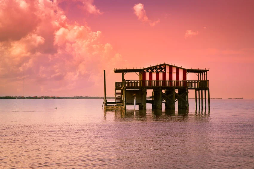 Historic fishing lodge on the water near Port Richey, Florida, at sunset, showing a classic Gulf Coast scene tied to local angling culture.