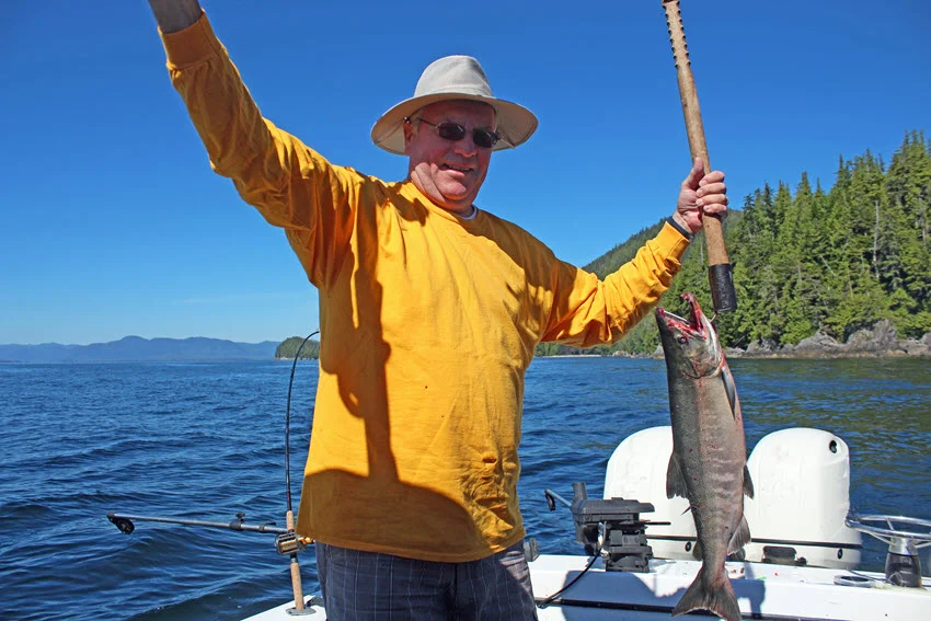 Boat angler fighting a strong fish with steady pressure and rod bend, matching common boat based Salmon techniques.