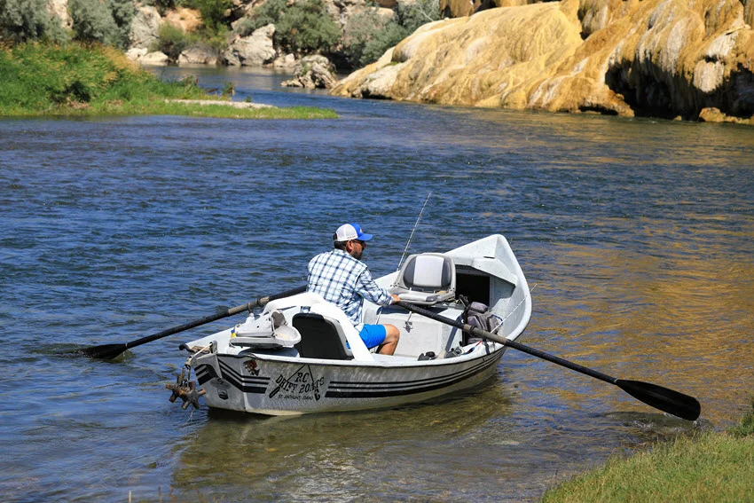 Drift boat setup on a river with anglers working current seams, a classic drift fishing approach for covering holding lanes efficiently.