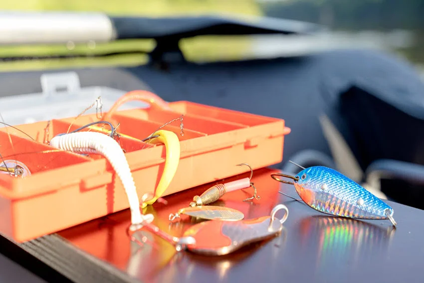 Close shot of a tackle box stocked with Salmon spoons, spinners, and leaders, a simple gear view that fits lure selection and on the water adjustments.