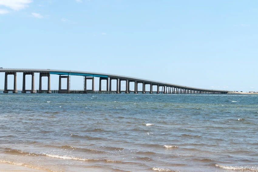 Pensacola Bay Bridge in Florida stretching over coastal water, showing the type of bridge structure where Sheepshead often feed around pilings.
