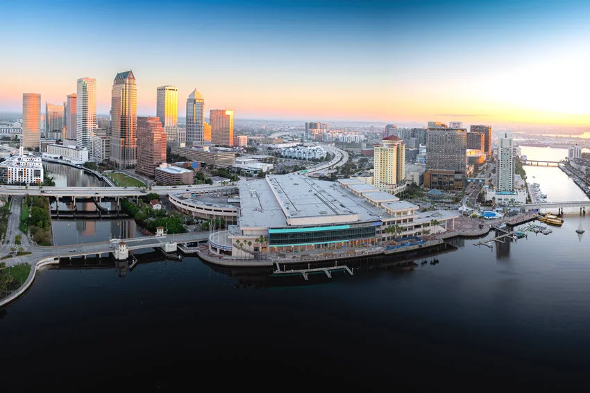 Tampa skyline at sunrise over the bay, highlighting a major Florida coastal area with bridges, docks, and inshore waters where Sheepshead are often targeted.
