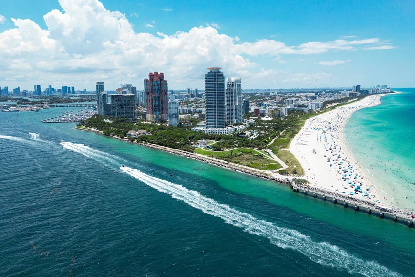 shutterstock_2509562775 &rarr; miami-coastline-sandbar-aerial &rarr; Aerial view of the Miami, Florida coastline with clear water and sandbars, highlighting shallow edges, troughs, and moving water that anglers often work along the beach zone.