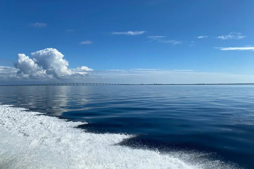 Sunrise view of calm deep blue Gulf of Mexico water.