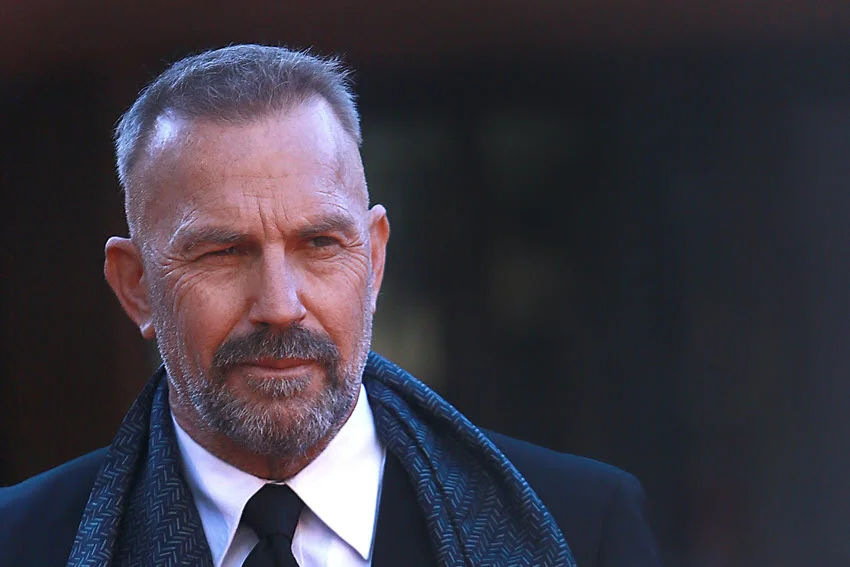 Kevin Costner in a suit on the red carpet at the Rome Film Fest.