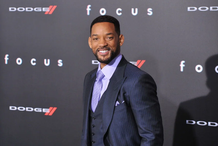 A dapper Will Smith poses under the camera lights at the 