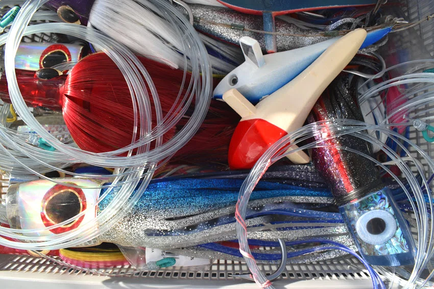 Assortment of colorful trolling lures prepared for big game fishing offshore.