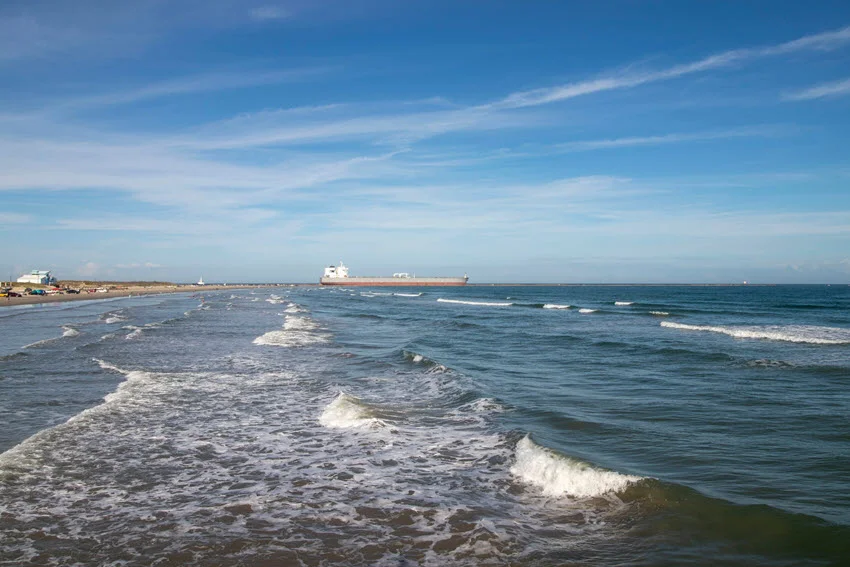 Shot from the beach of Aransas Bay, capturing rolling waves under the sunlight.
